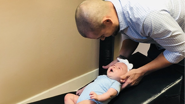 Chiropractor Port Allen LA Dane Owens Adjusting Pediatric Patient